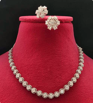 White CZ necklace set with silver finish, featuring a 20 cm delicate necklace and 1×1.5 cm matching earrings. Lightweight and refined festive jewelry.