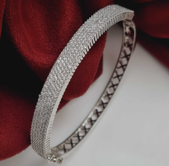 Silver Marcellina Kada on red velvet – rhodium plated CZ bracelet