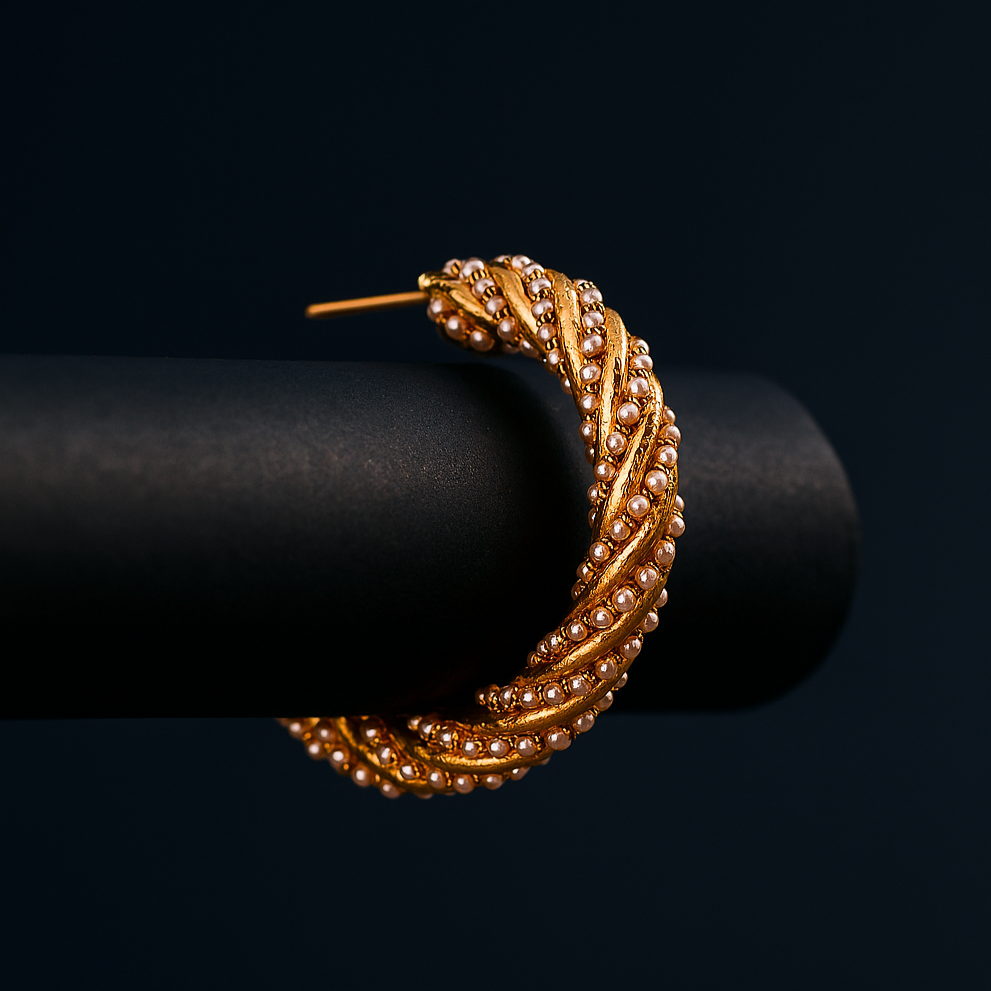 Gold hoop earring on a black background