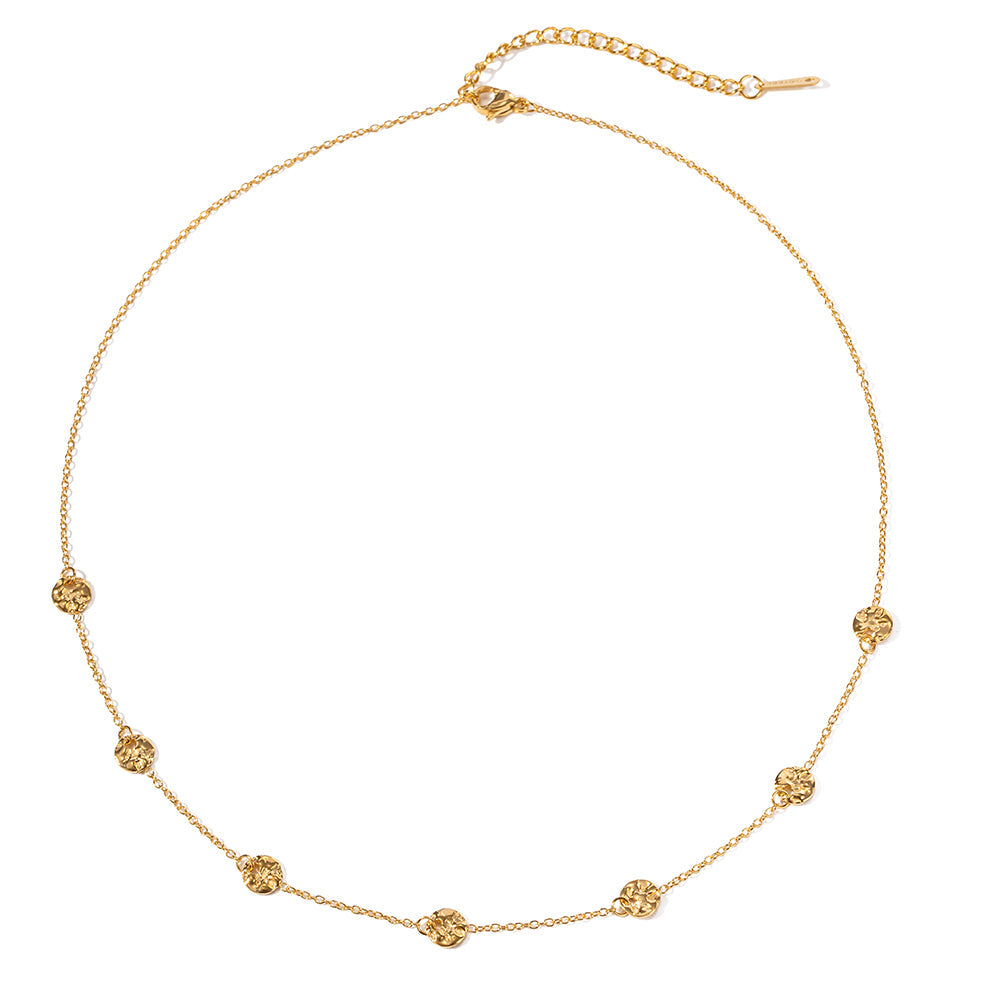 Elysian Gold Necklace – delicate gold chain with textured round charms on white background