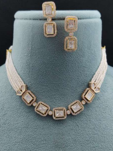 Amore pearl kundan necklace with rectangular stone earrings displayed on velvet teal bust