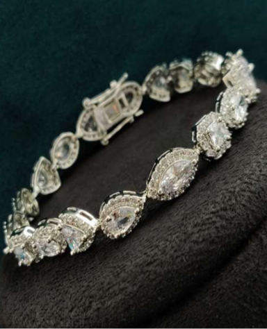 Silver-finished CZ bracelet with pear-shaped and round white stones, inspired by solitaire styling. Lightweight fashion jewelry piece by Lavish Jewels.