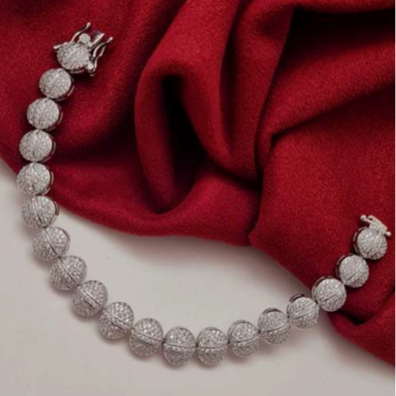 White CZ charm bracelet in silver finish with round American diamond-style stones, lightweight and elegant for festive or everyday wear.