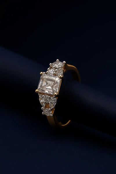"Elegant gold engagement ring with emerald-cut center stone and pear-shaped side CZ - Lavish Jewels Australia"