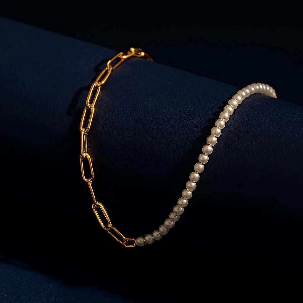 "18K PVD gold-plated pearl chain necklace displayed on black cylindrical surface with elegant lighting - premium stainless steel tarnish-free jewelry"