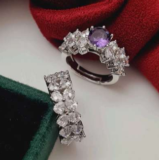 Two-in-one fancy CZ finger ring with purple and white stones on red velvet background