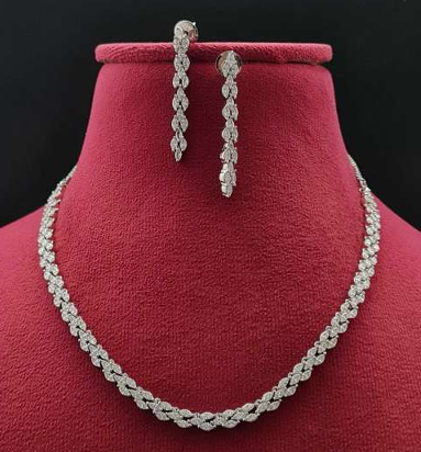 Silver finish AD necklace and earring set with delicate leaf-shaped CZ detailing. Lightweight, adjustable bridal and festive jewelry by Lavish Jewels.
