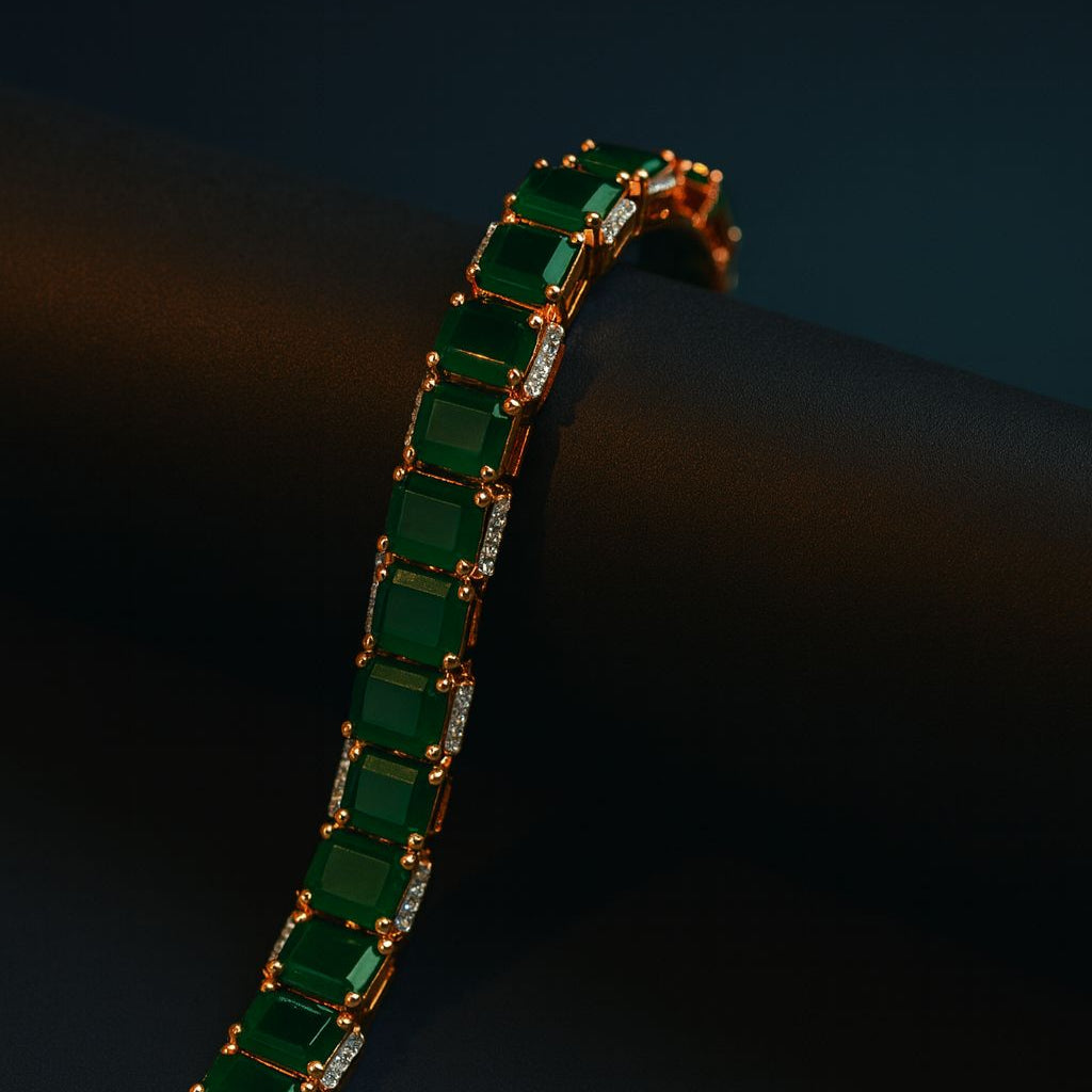 Emerald green CZ bracelet with white rhodium plating, featuring emerald-cut cubic zirconia stones in a classic linear design. Elegant festive jewelry piece by Lavish Jewels.