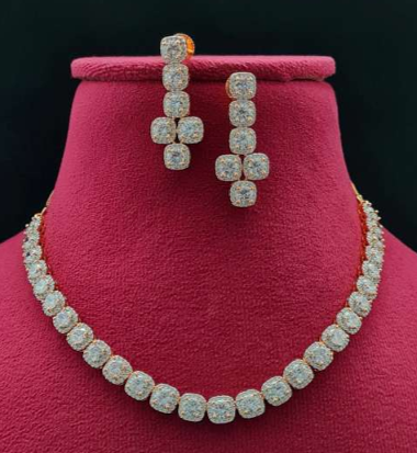 “Luce gold white delicate AD necklace set with matching earrings on white bust stand – Lavish Jewels”