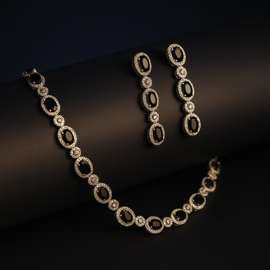 “Cielo necklace and earrings displayed on a velvet red bust with black CZ stones and white plating”

