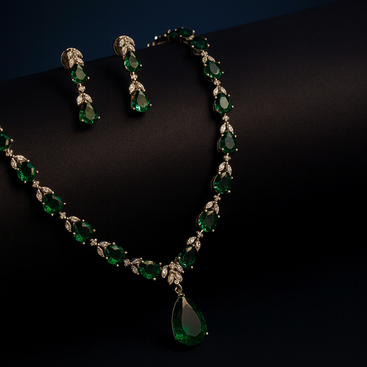  “Luna Milano delicate CZ necklace set on a velvet bust, featuring green teardrop stones with white plating.”