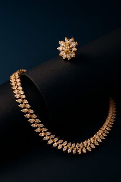 Gold necklace and earring set on a black background- LAVISH JEWELS