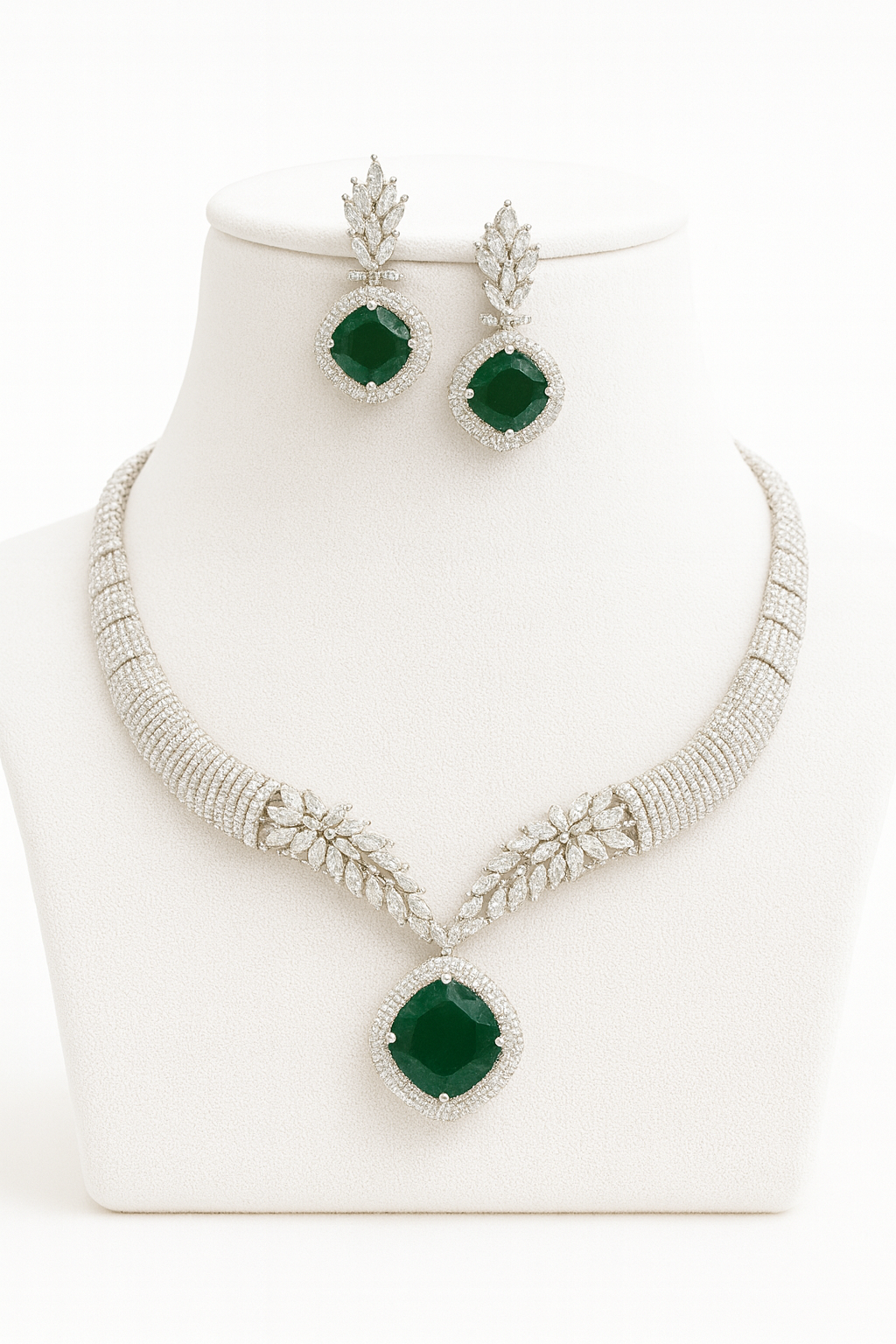 Front view of Saanjh green necklace and earrings set on white bust stand
