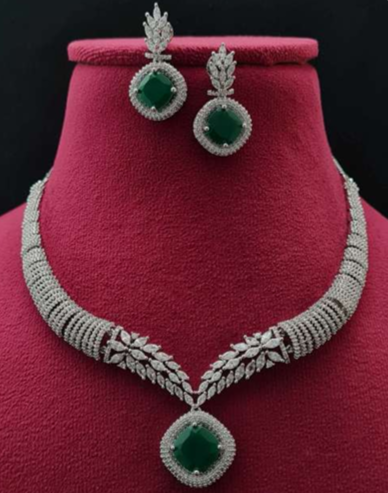 Saanjh green CZ necklace set with rhodium plating displayed on red velvet bust