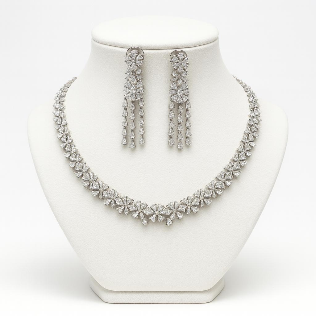 Silver necklace and earrings set on a white mannequin bust.