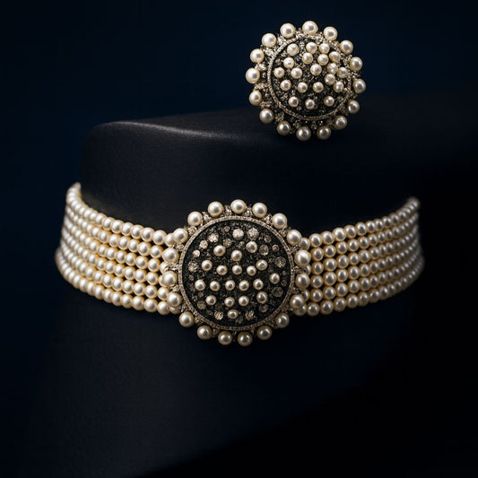 Empress Halo choker and earring displayed on black cylindrical surface with deep blue background