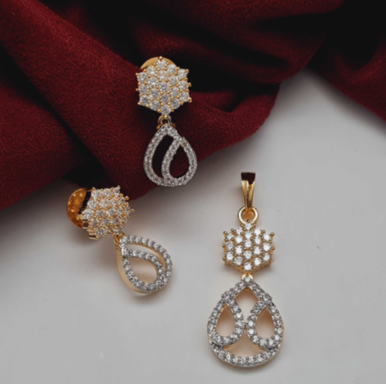 Elegant CZ Golden Pendant Set with matching earrings (no chain) – rhodium-plated brass design on red fabric background
