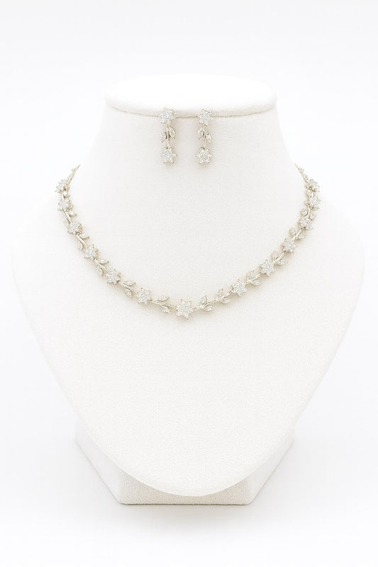 Venezia Shine white CZ floral necklace and earring set shown on white bust stand against white background
