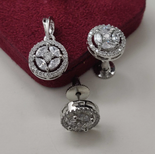 Exclusive CZ White Pendant Set with matching earrings (no chain) – rhodium-plated brass design on red fabric background