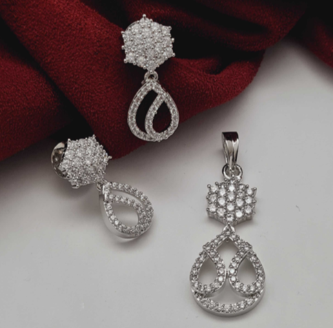 Elegant CZ Silver Pendant Set with matching earrings (no chain) – rhodium-plated brass design on red fabric background