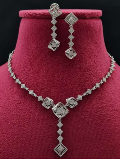  Roma Eleganza designer necklace set styled on black bust with moody spotlight for editorial look