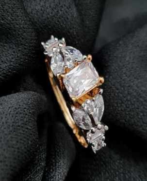 Dolce Nodo gold-plated AD ring on black fabric background with sparkling CZ stones