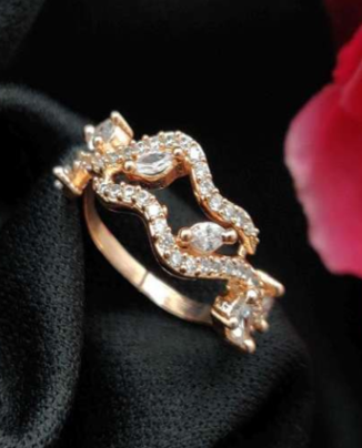 Sogno Marino gold-plated CZ ring resting on black fabric with floral background