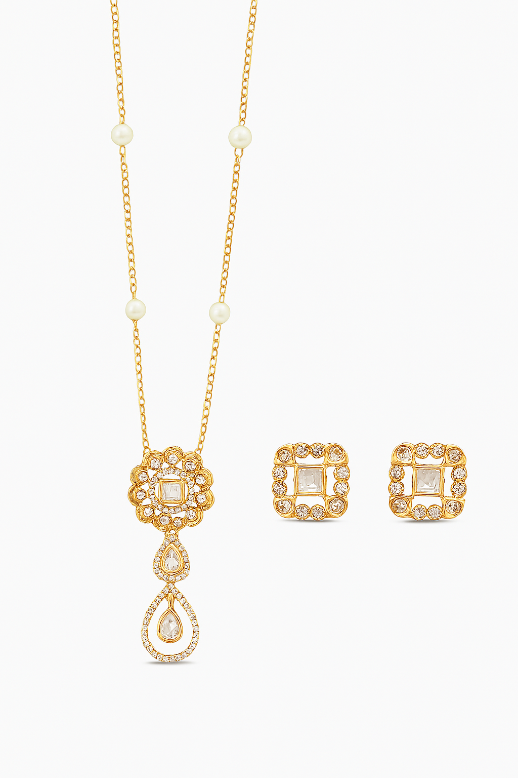 Gold necklace and earrings set on a white background