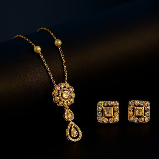Gold necklace and earrings on a dark background