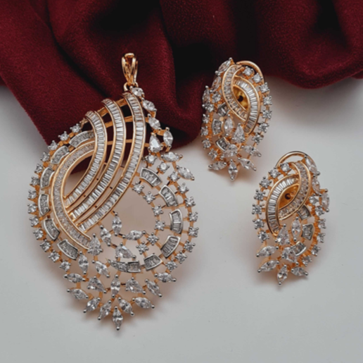 Glamorous Elegant CZ Pendant Set with matching earrings – gold-plated brass design with cubic zirconia stones on red fabric background