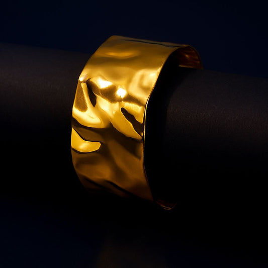 Gold bracelet on a black background