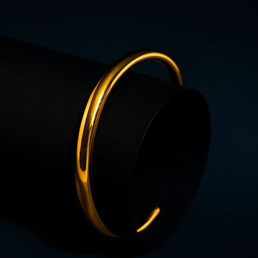 Gold bracelet on a black background