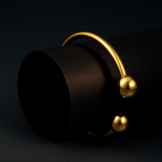 Black bucket with a gold handle on a black background
