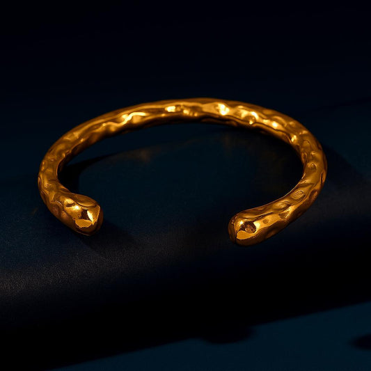 Gold bracelet on a dark background