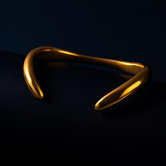 Gold bracelet on a black background
