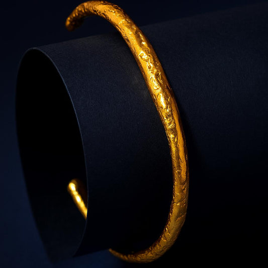 Gold bracelet on a black background