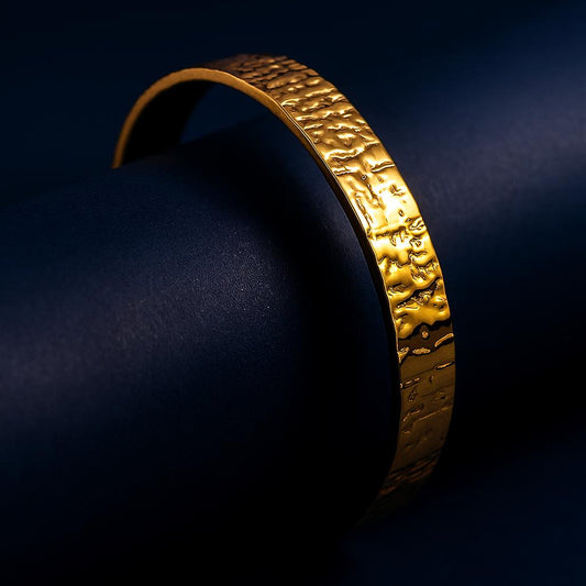Gold bracelet on a dark blue background