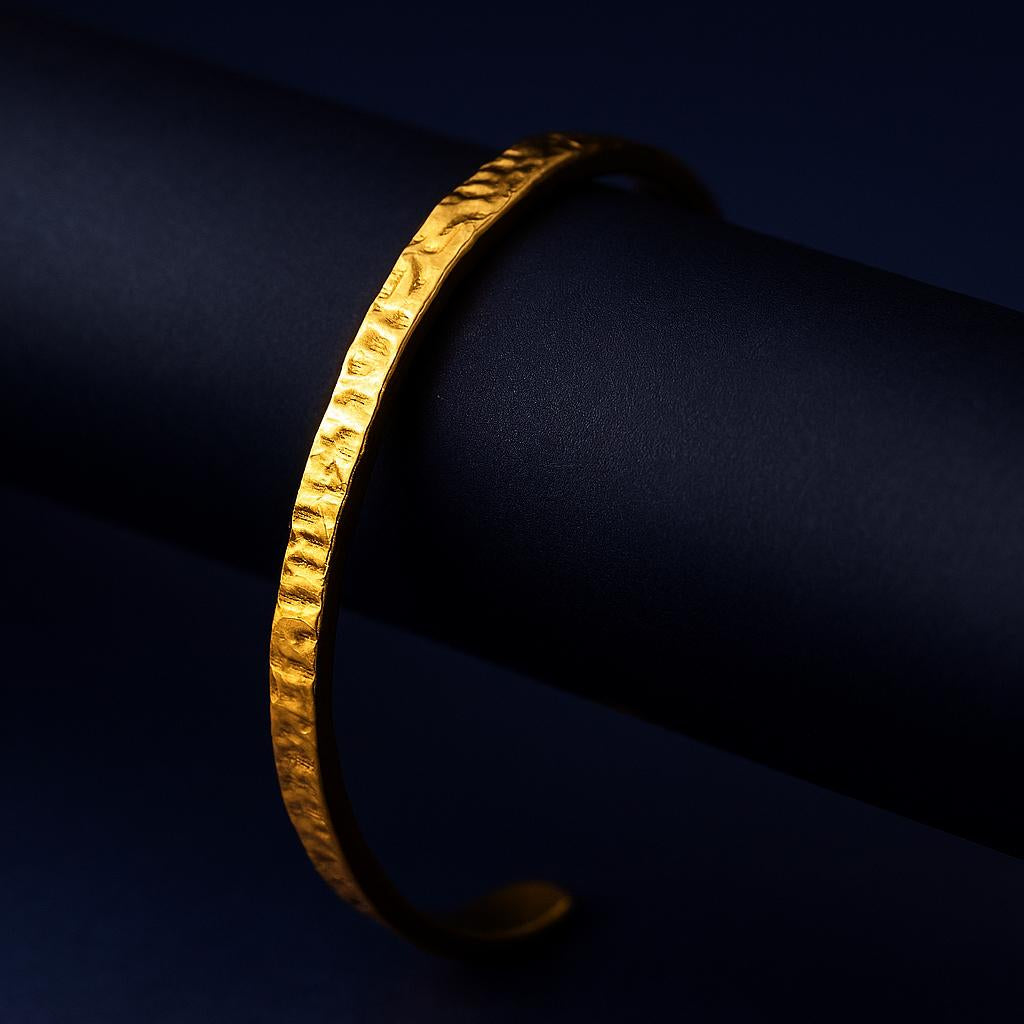 Gold bracelet on a dark background
