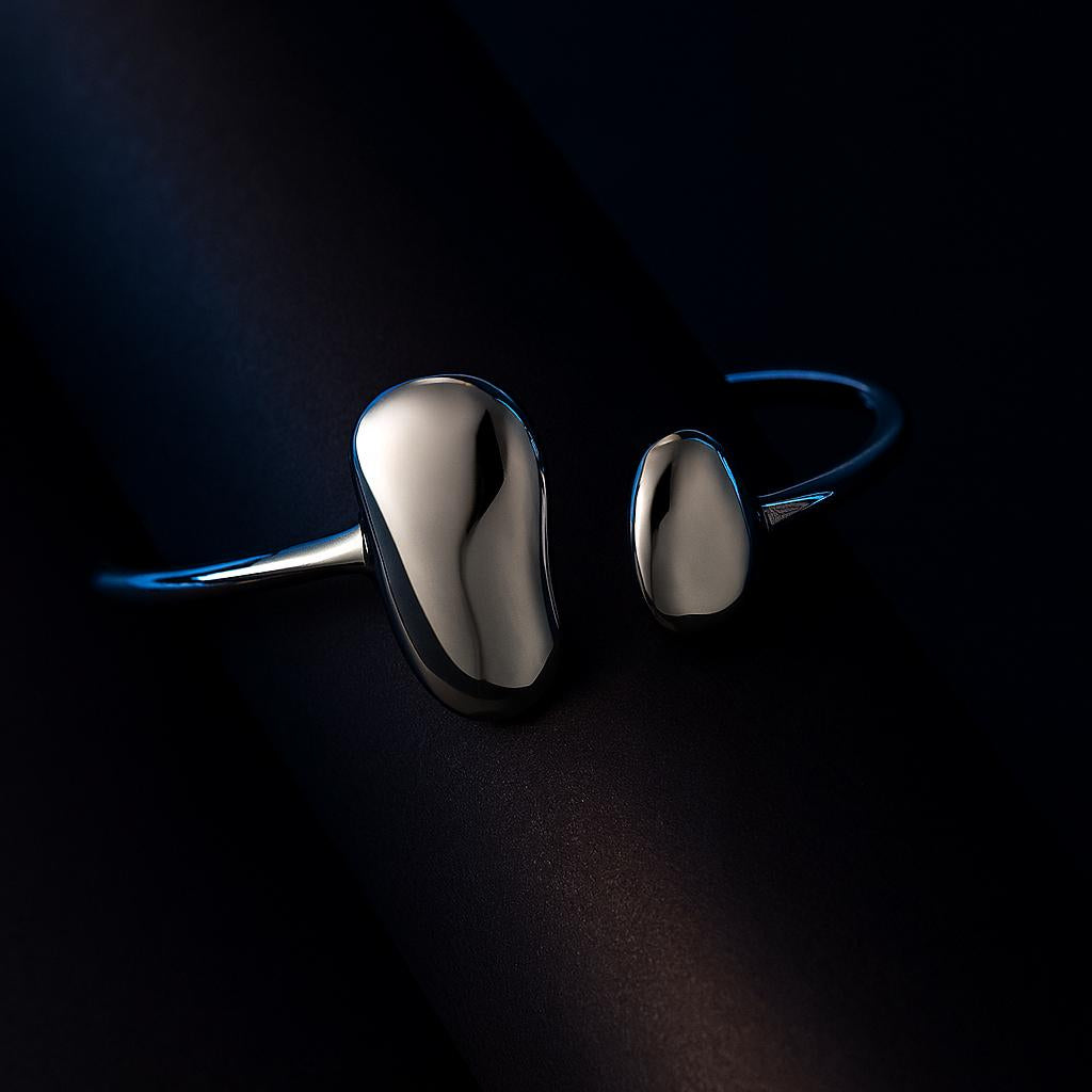 Pair of silver earrings on a dark background
