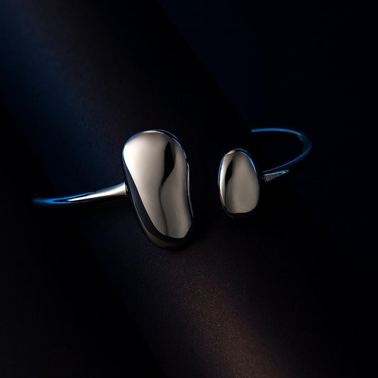 Pair of silver earrings on a dark background