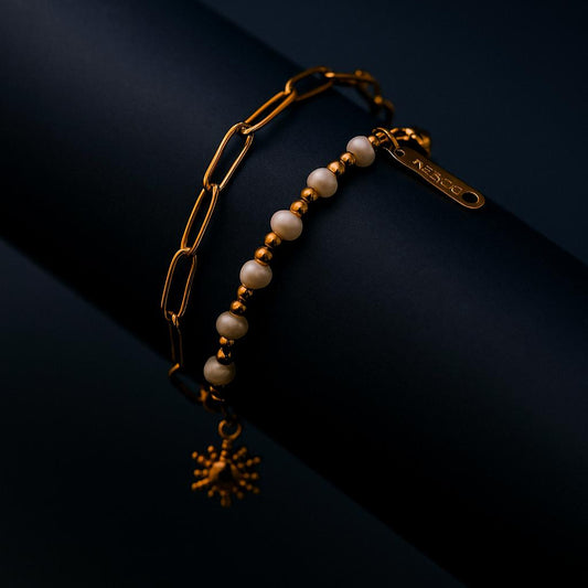 Gold and pearl bracelet on a dark background
