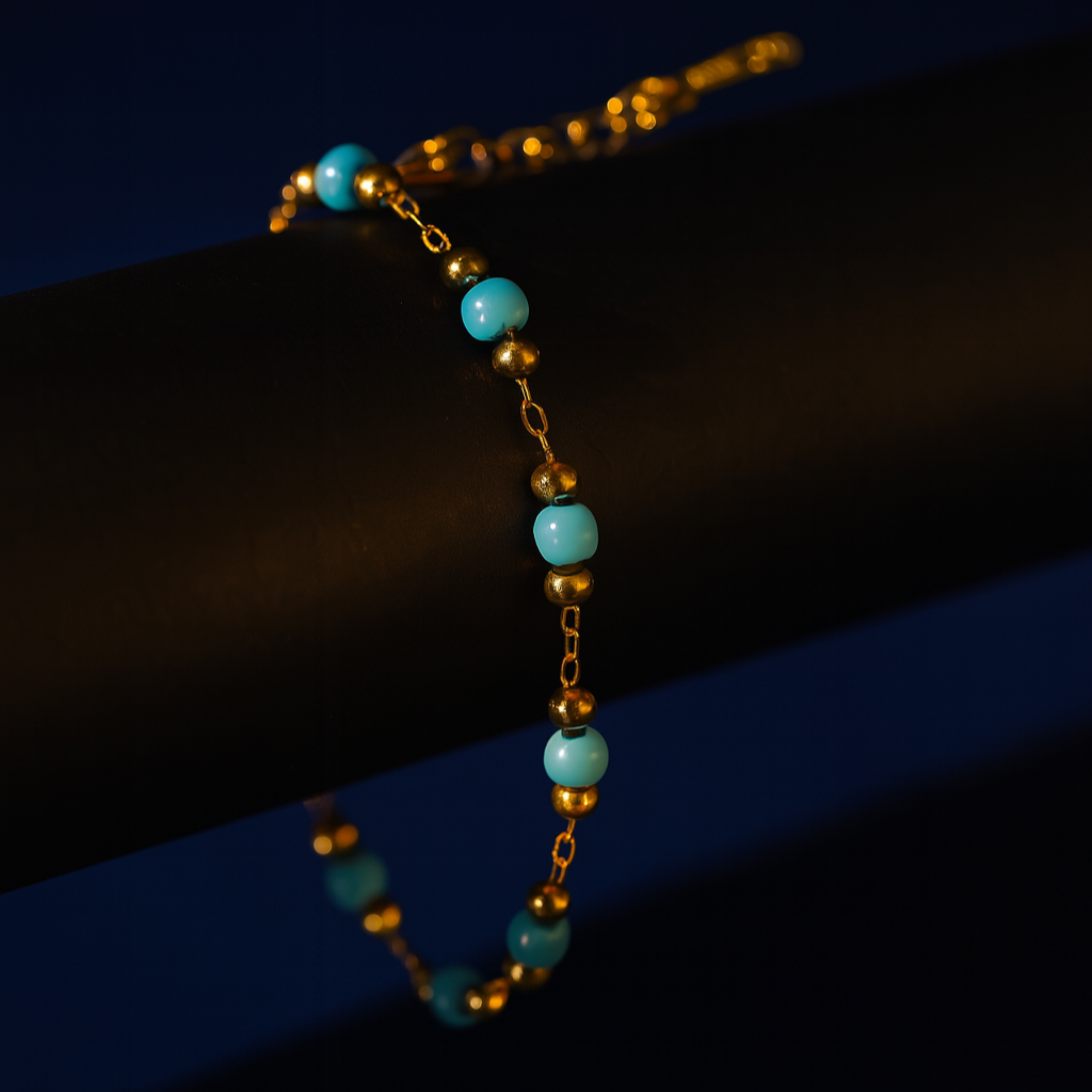 Bracelet with turquoise beads and gold accents on a dark background