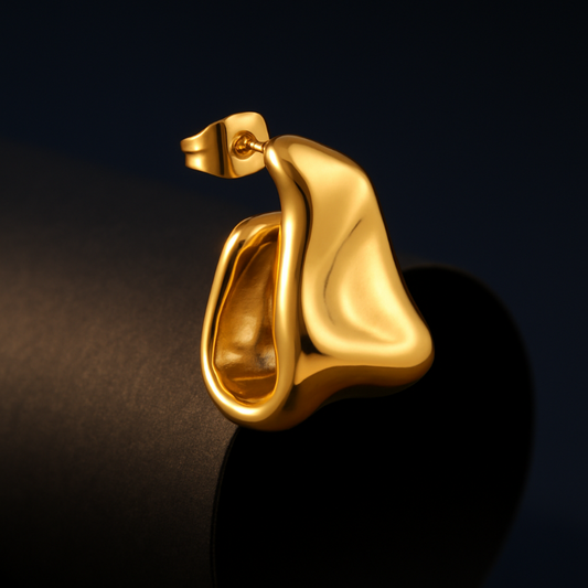 Gold earring on a dark background