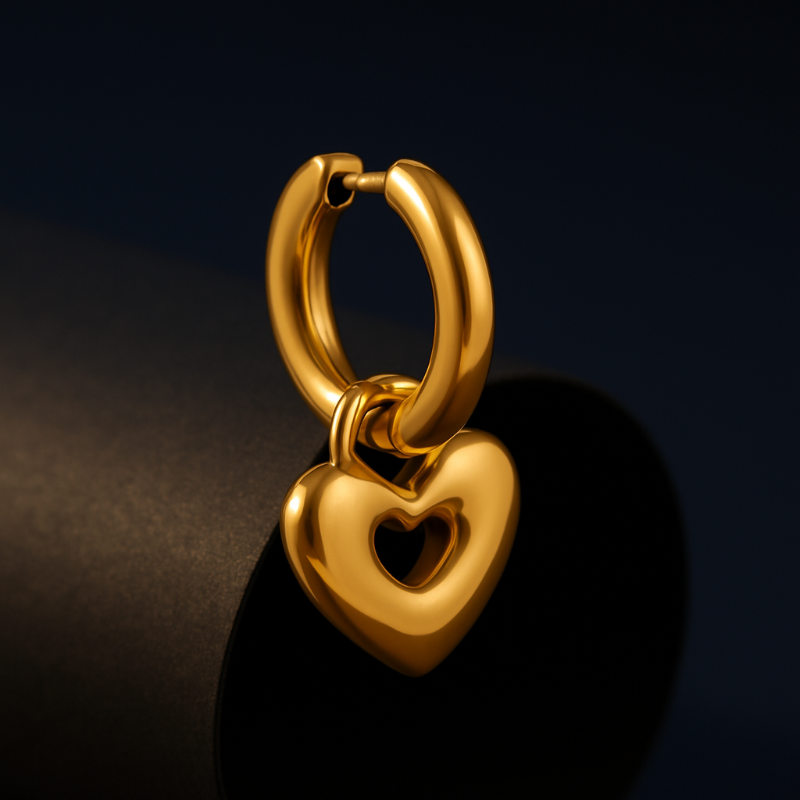 Gold heart-shaped earring on a dark background