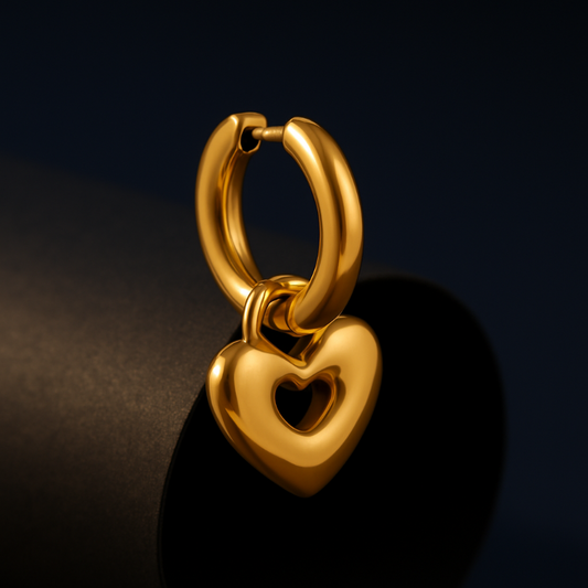 Gold heart-shaped earring on a dark background