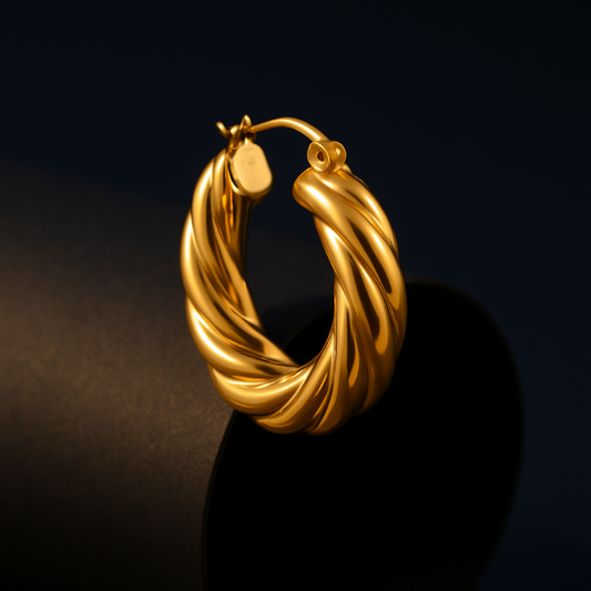 Gold hoop earring on a dark background