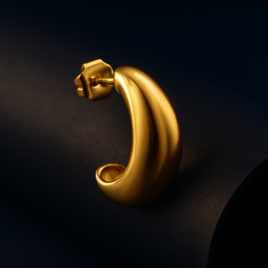 Gold earring on a dark background