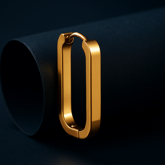 Gold hoop earring on a dark background