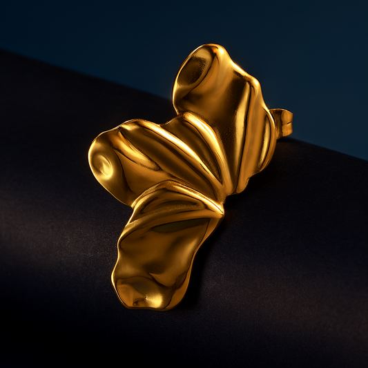 Gold leaf-shaped object on a dark background