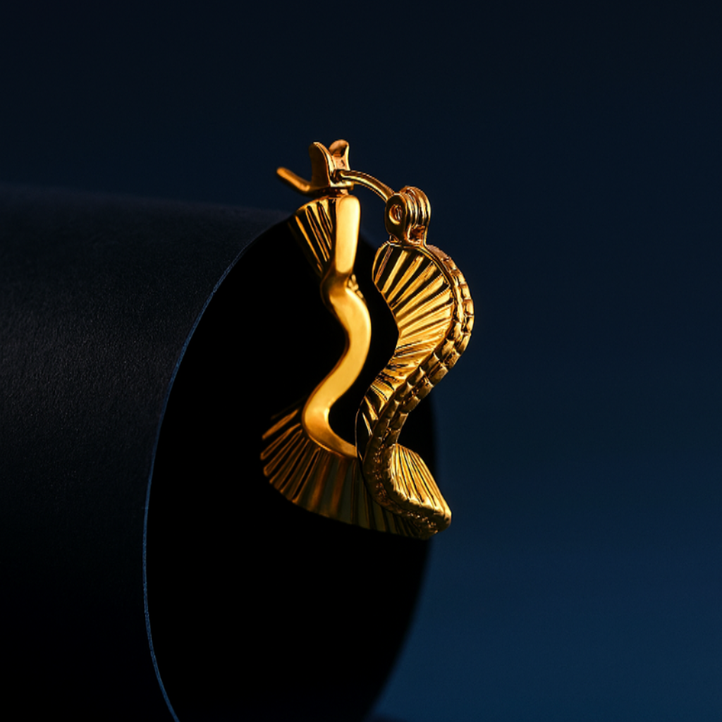 Gold fish-shaped pendant on a black background